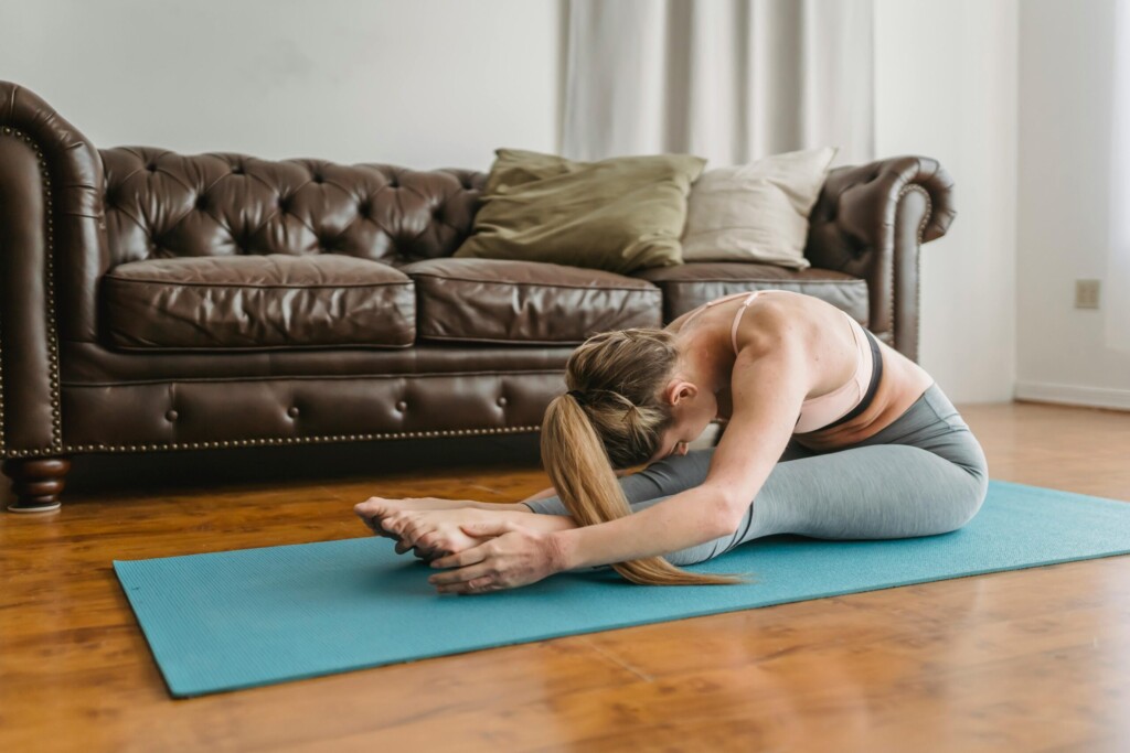 women doing Seated Forward Fold (Paschimottanasana)