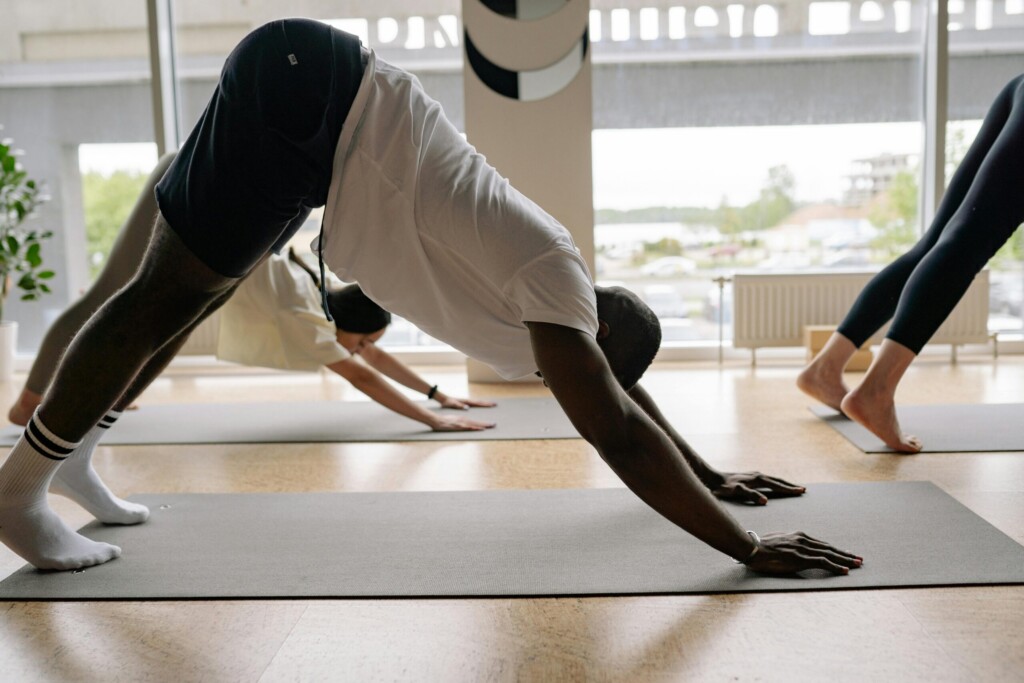 men doing Downward-Facing Dog pose
